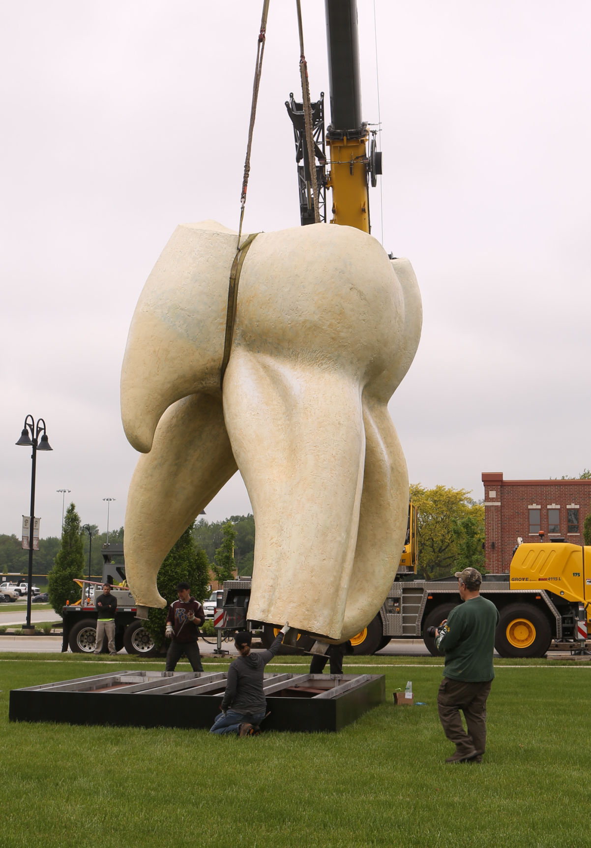 Artist Seward Johnson's "The Tooth" is implanted at the Crown Point Sportsplex